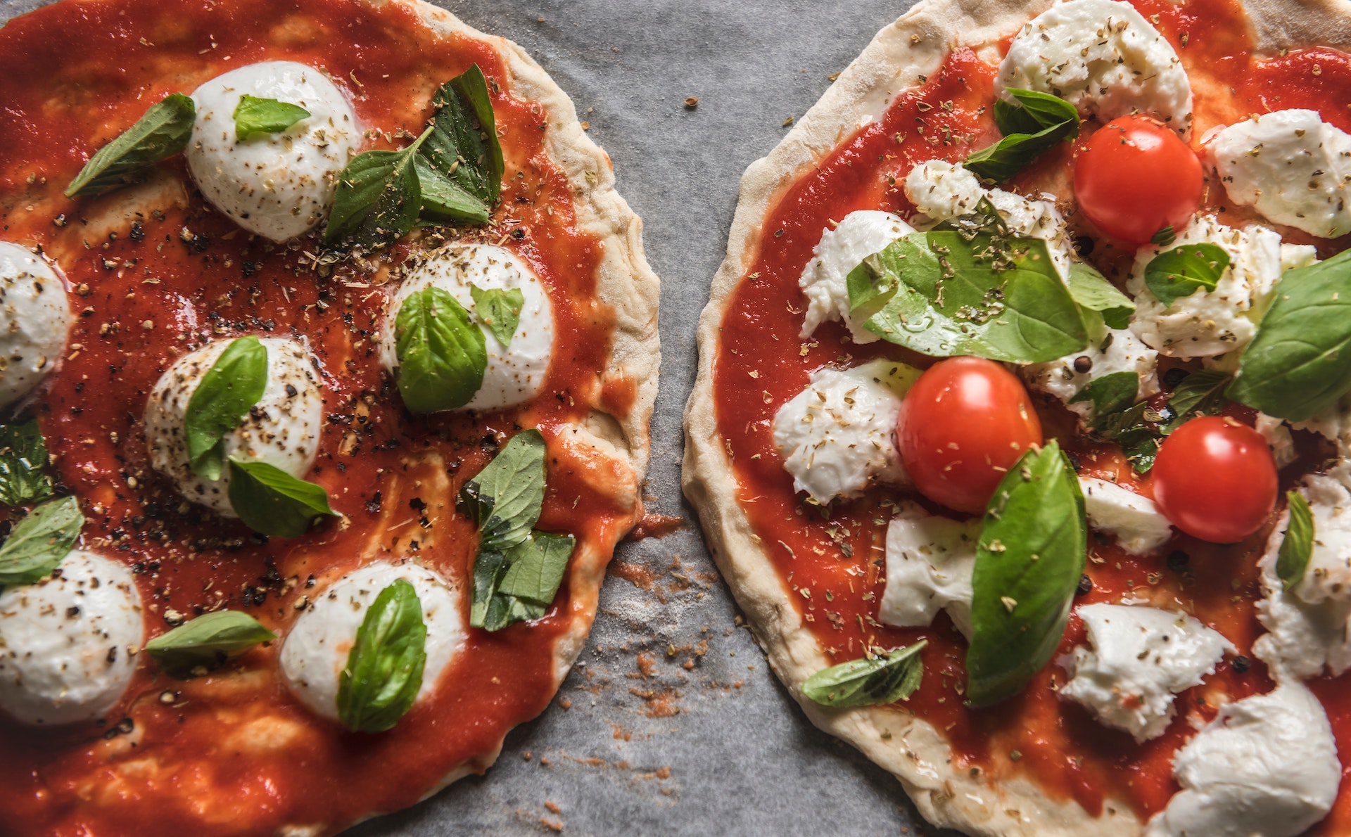 two pizzas on a countertop