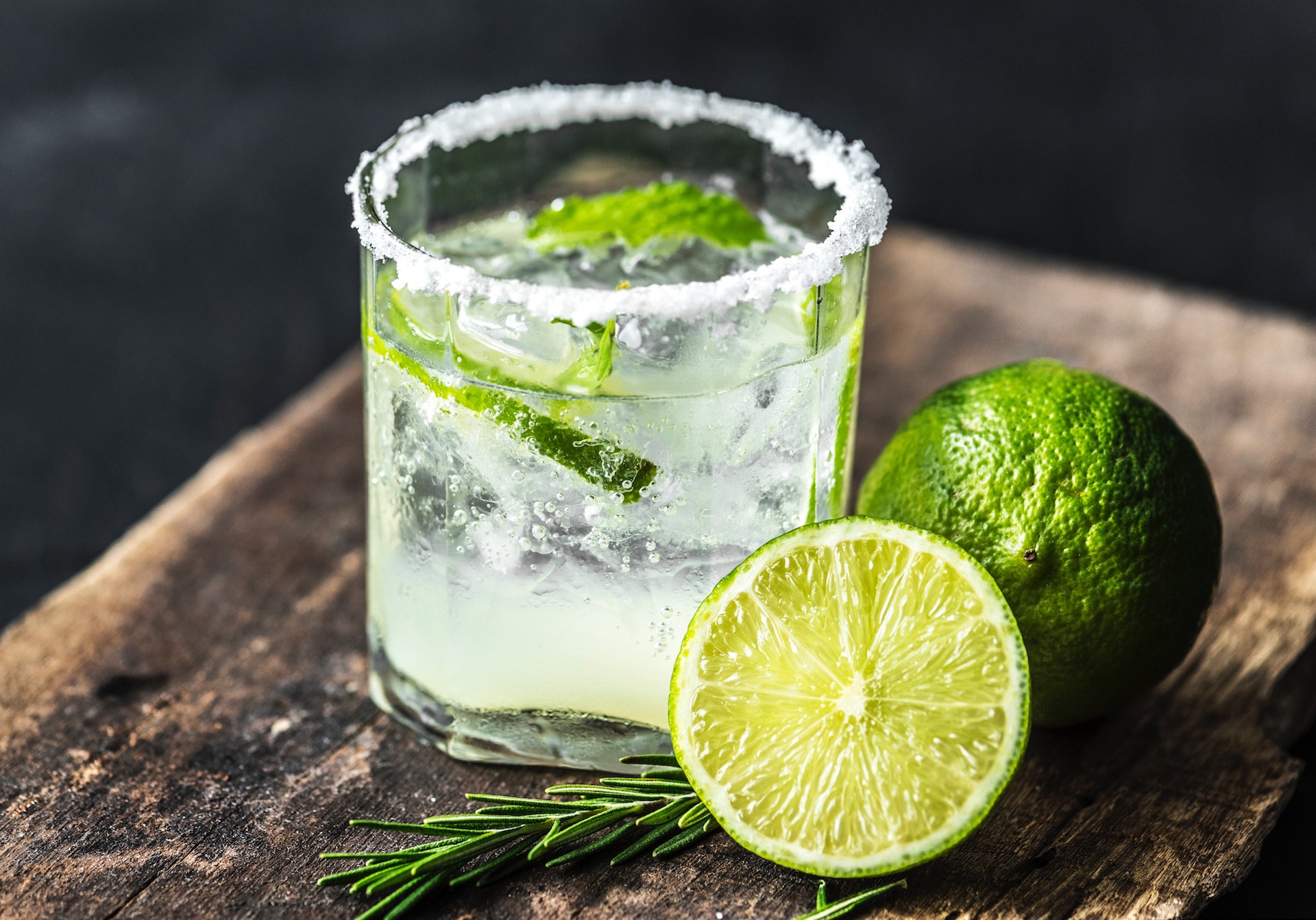 a cocktail with lime and rosemary